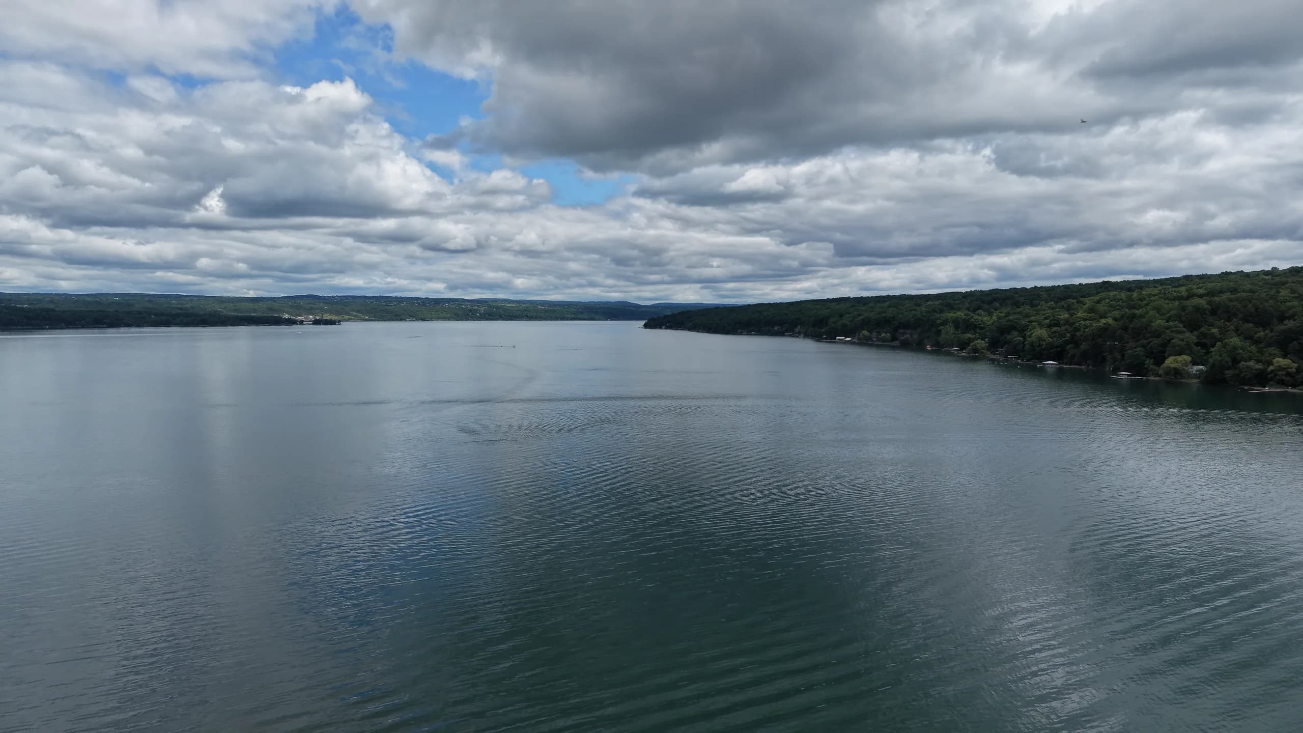 Mid-day wide shot of Seneca Lake between the two shores