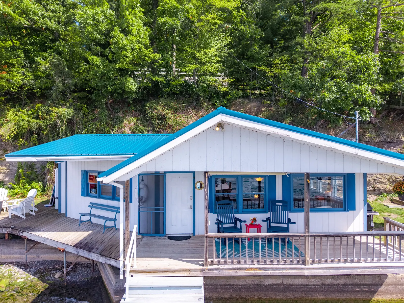 Smooth Sailing FLX — waterfront cottage from the lake, blue-and-white board-and-batten with a covered dock porch
